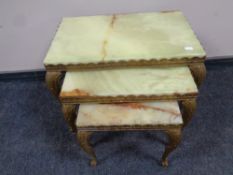A nest of three Italian brass and onyx tables