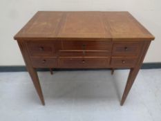 A late 19th century inlaid mahogany vanity table on raised legs fitted slide and five drawers