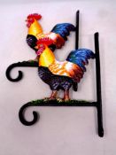 A pair of cast iron cockerel hanging basket brackets