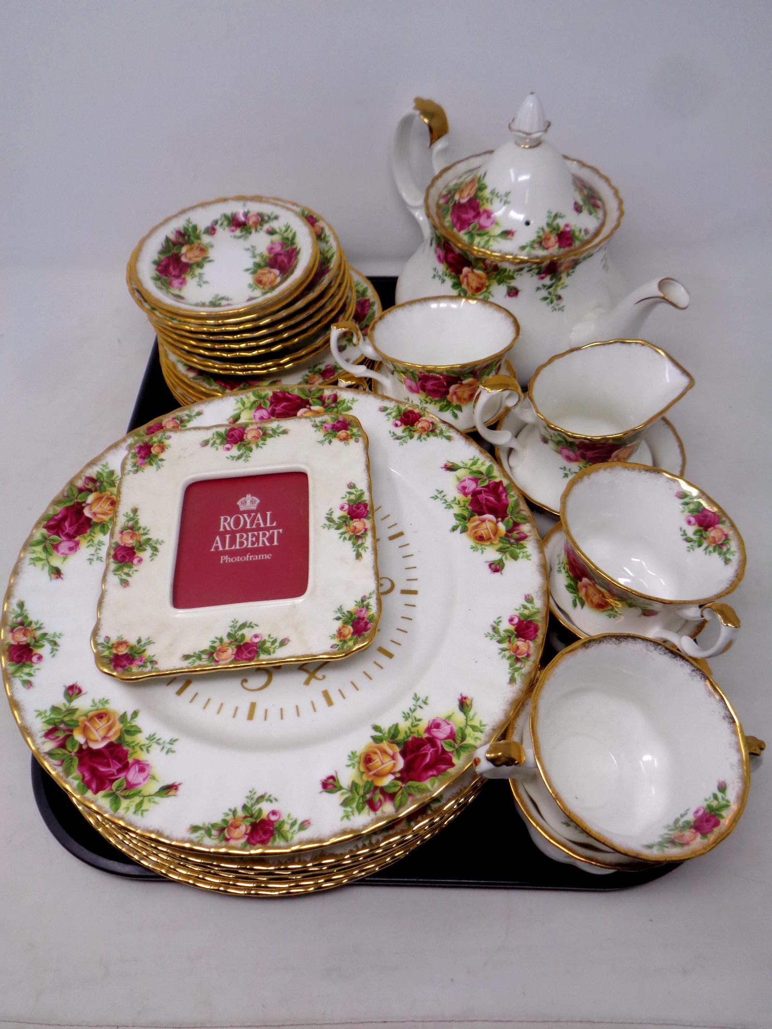 A tray containing 31 pieces of Royal Albert Old Country Roses tea and dinner china, photo frame,