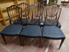 A set of six mahogany shield back dining chairs with black fabric seats