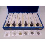 A coin collector's case containing a quantity of American quarter dollars and Euro coins