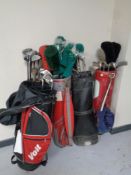 Five golf bags containing a quantity of assorted irons, drivers and putters to include Wilson,