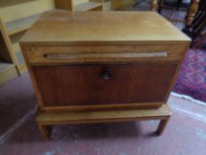 An Art Deco fall front cabinet fitted a drawer