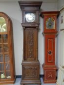 A carved oak black forest style longcase clock with brass and silvered dial