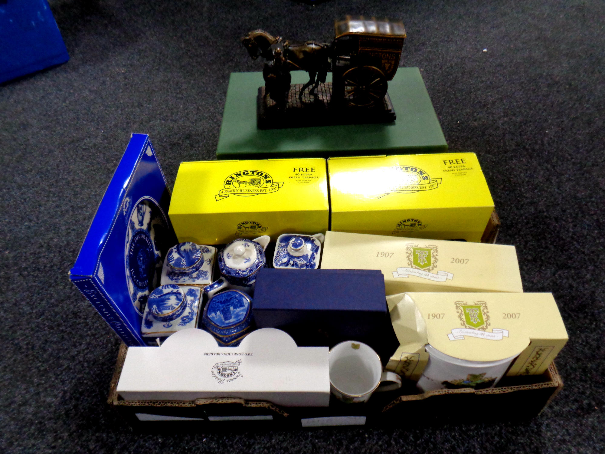 A box containing assorted Ringtons china to include money boxes, caddies, teapots, mugs,