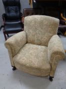 An early 20th century armchair upholstered in a floral fabric