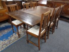 An Edwardian oak pull out dining table together with six chairs