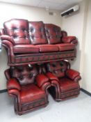 A Chesterfield style red leather upholstered three piece suite