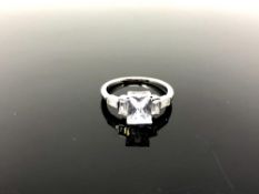 An Art Deco style silver ring set with a clear stone,