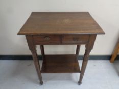 An early 20th century two tier occasional table fitted two drawers