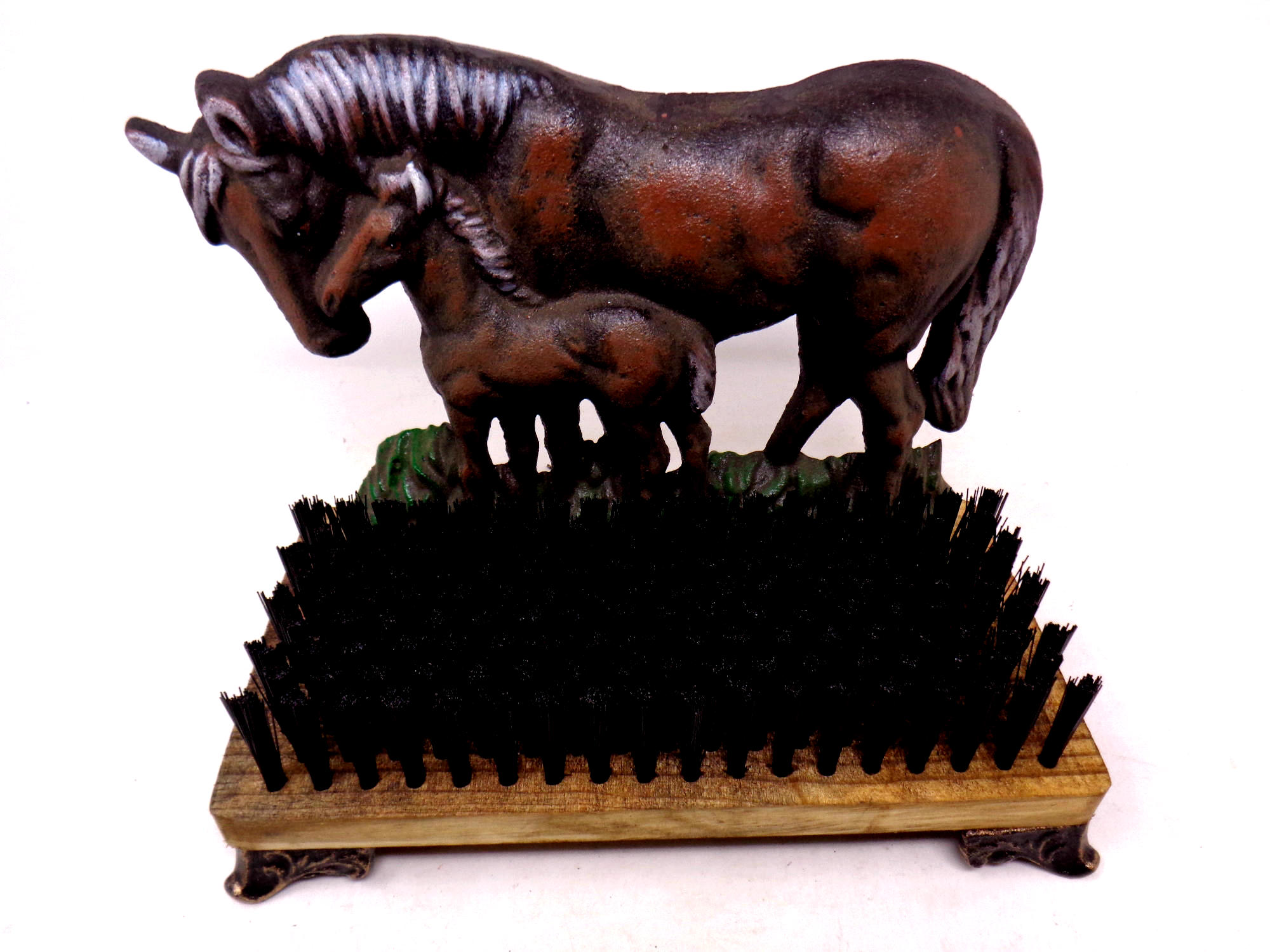 A cast iron horse door stop with boot brush