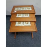 A nest of three mid 20th century teak tile topped tables