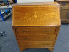 A Victorian marquetry inlaid fall front bureau fitted three drawers beneath