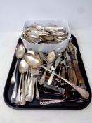 A tray containing a large quantity of plated flatware, serving spoons, berry spoons, knife stands,