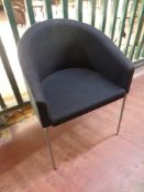 A Skovby tub chair upholstered in a black fabric on metal legs