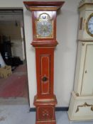 A continental painted longcase clock with brass and silvered dial