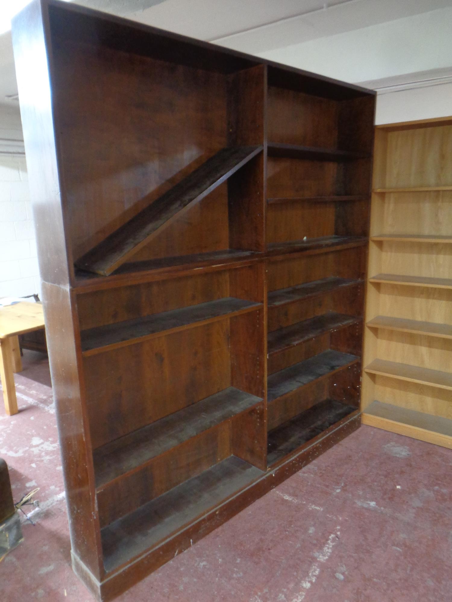 A set of mid 20th century open bookshelves, 219 cm high x 200.5 cm wide x 25 cm deep.