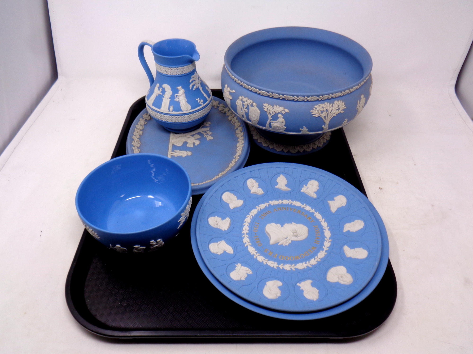 A tray containing six pieces of Wedgwood Jasperware to include anniversary plates, bowl,
