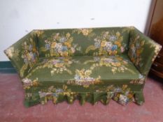 A 20th century settee upholstered in a green floral fabric