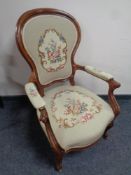 An antique mahogany armchair on cabriole legs upholstered in a tapestry fabric