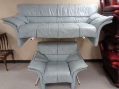 A mid 20th century three seater settee and armchair upholstered in a blue leather