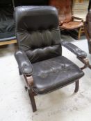 A 20th century Scandinavian stained beech framed armchair upholstered in black leather