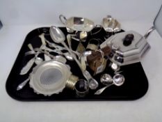 A collection of silver plated items to include three piece tea service, basting spoon,