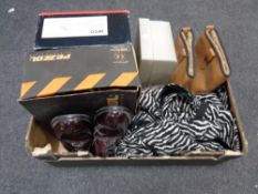 A box containing assorted shoes, work boots,