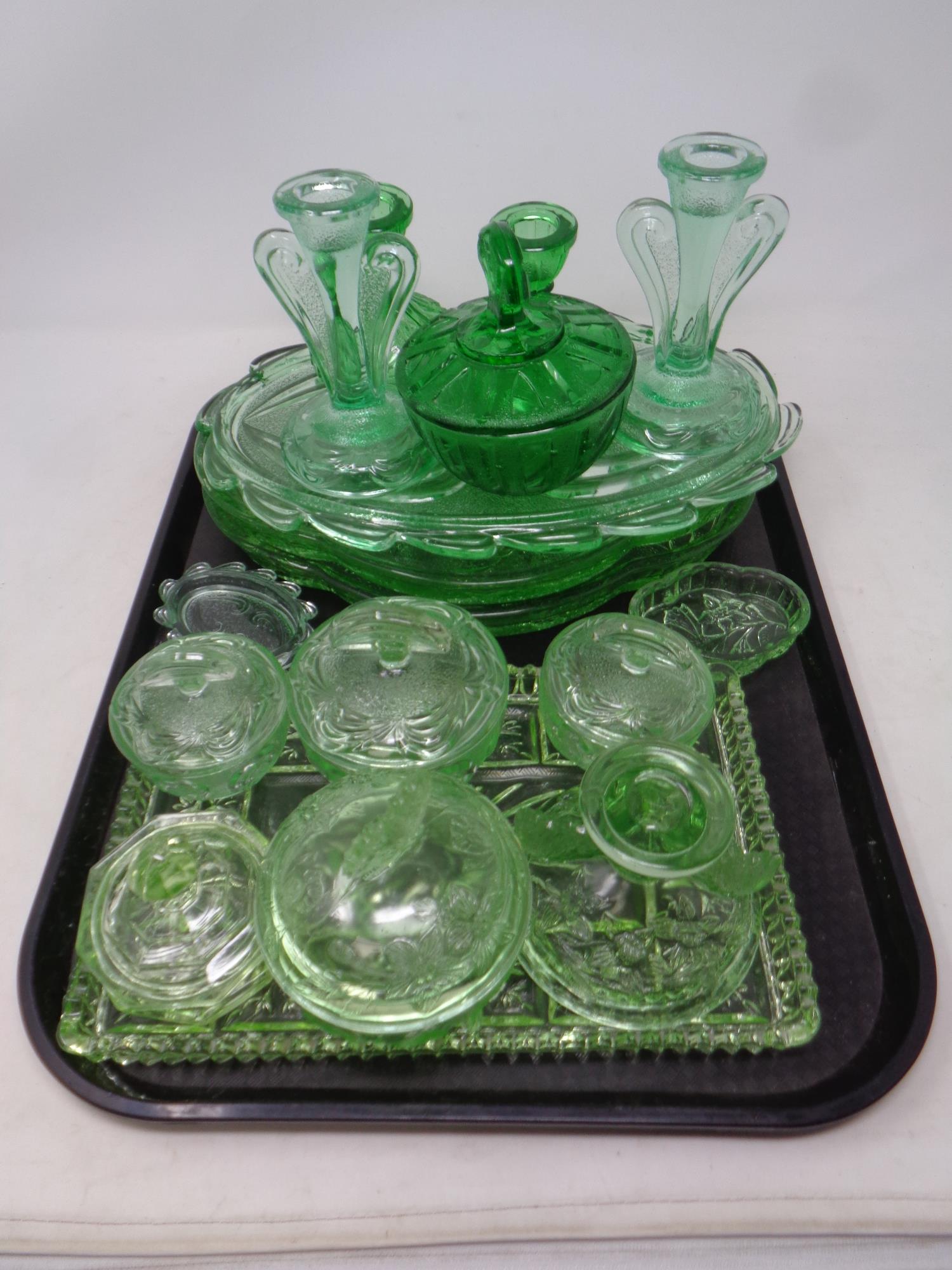 A tray containing 1930s green glass trinket trays,