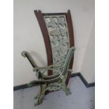 A pair of cast iron bench ends together with a cast iron bench back