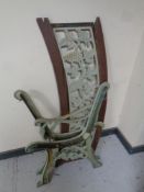 A pair of cast iron bench ends together with a cast iron bench back