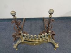 A pair of 19th century wrought iron and brass fire dogs together with a brass fire front