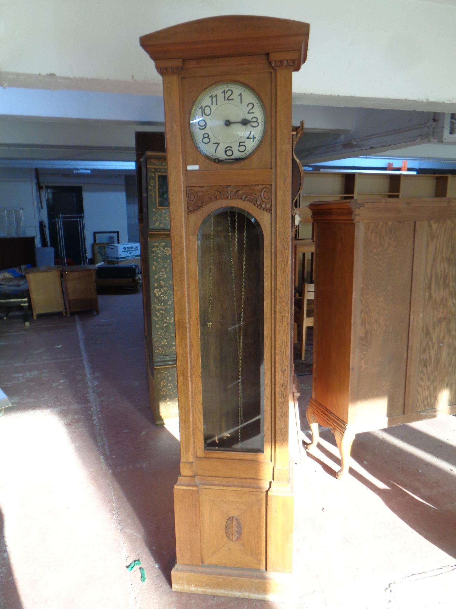 A carved oak cased regulator clock with circular silvered dial