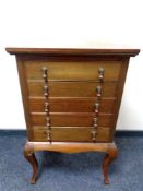 An Edwardian mahogany five drawer music chest on cabriole legs