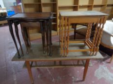 A mid 20th century teak coffee table with rattan undershelf (as found) together with two nests of