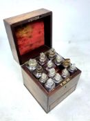 A fine Regency mahogany apothecary cabinet, the lid revealing twelve glass bottles,