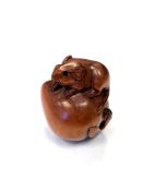 A Japanese carved fruitwood netsuke - A rat on a pumpkin.