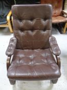 A 20th century Scandinavian stained beech framed armchair upholstered in brown leather