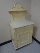 A late 19th century painted pine marble topped wash stand, 125 cm high x 63 cm wide x 42 cm deep.