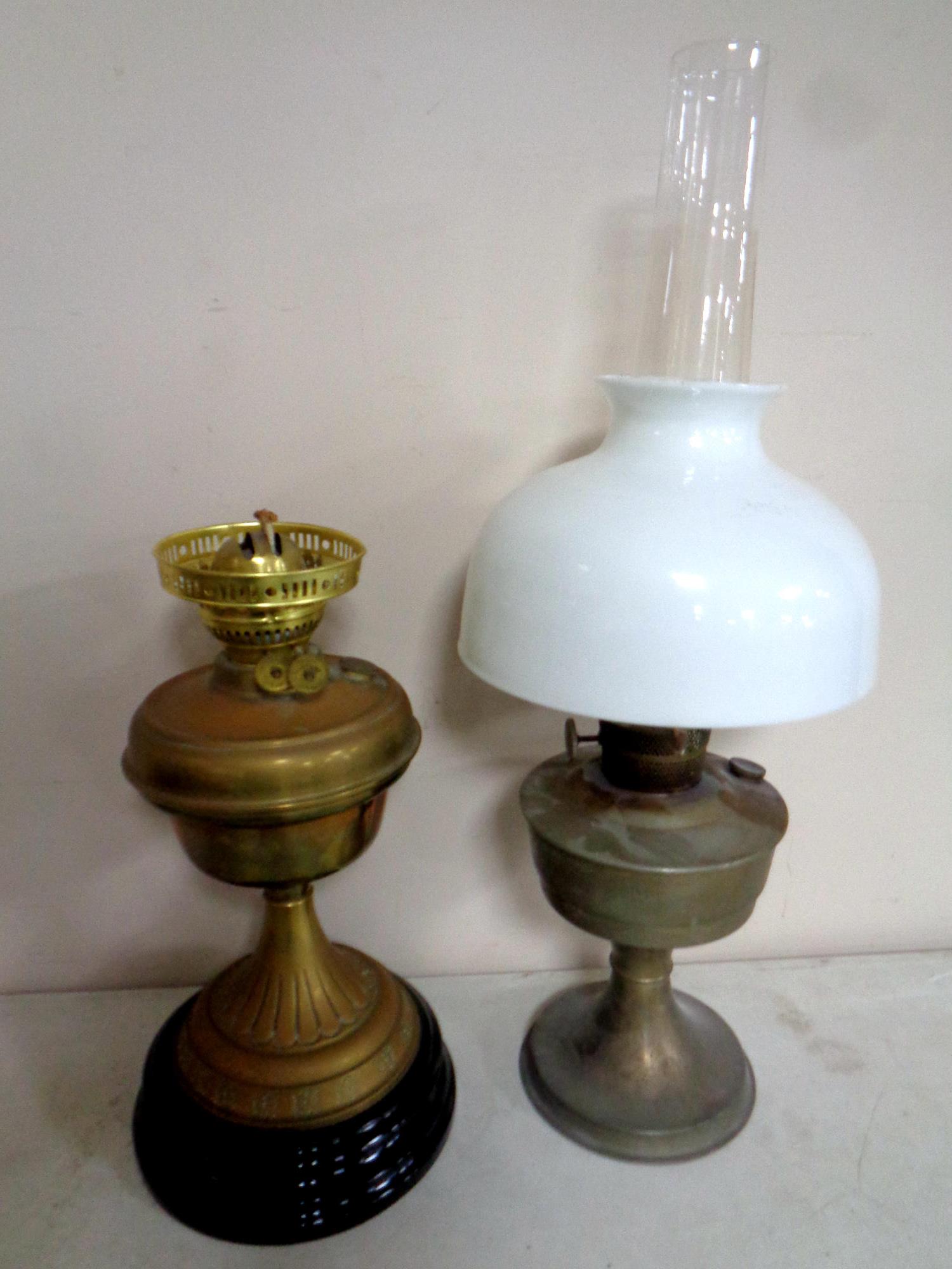 A brass Duplex oil lamp on ceramic base together with a further chrome oil lamp with glass chimney