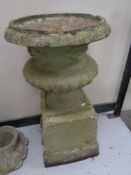A concrete urn on stand