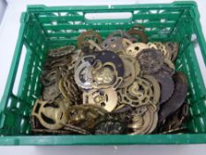 A crate containing a large quantity of horse brasses