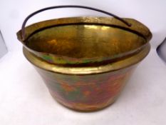 An antique hammered copper cast iron handled jam pan