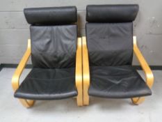 A pair of Ikea beech framed armchairs with black leather cushions