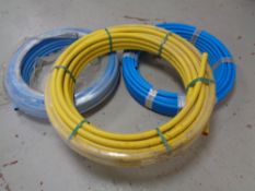 Three spools of plastic gas piping