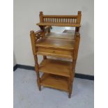 A pine three tier mirrored back telephone table fitted a drawer