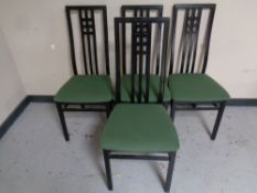 A set of four contemporary black high backed dining chairs