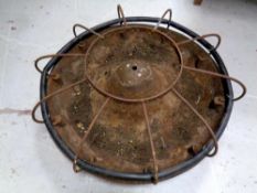 A circular cast iron pig feeding trough
