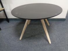 A contemporary two tone circular coffee table